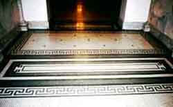 Ceramic mosaic tiles are a practical floor covering in the entryway of this early 20th century school building.