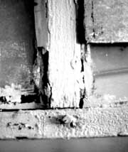 This historic double-hung window has many layers of paint, some cracked and missing putty, slight separation at the joints, broken sash cords, and one cracked pane.