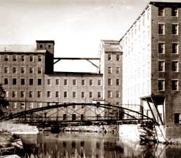 Windows are frequently important visual focal points, especially on simple facades such as this mill building. Replacement of the multi-pane windows with larger panes could dramatically alter the appearance of the building.